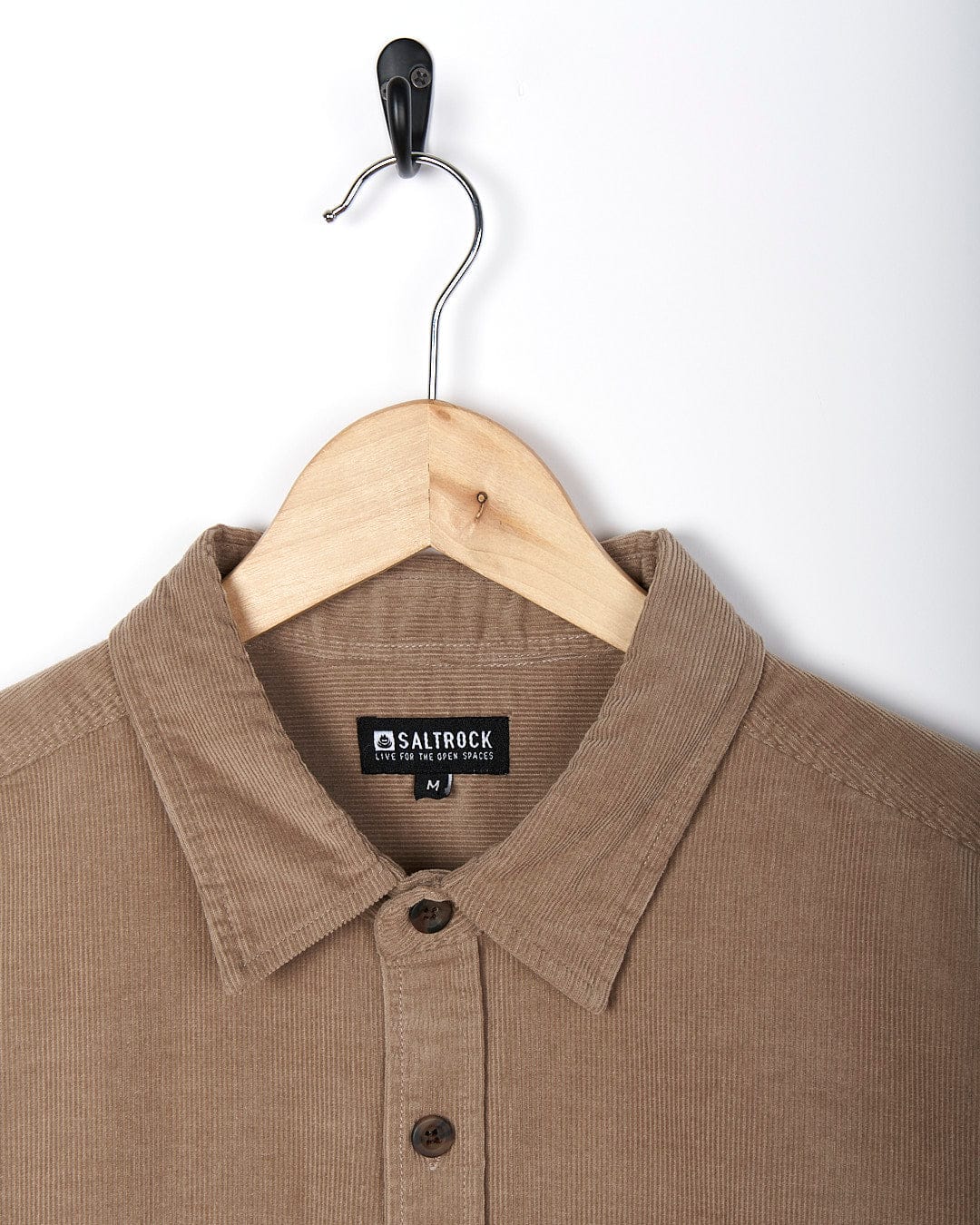 A Saltrock - Men Corduroy Shirt - Light Brown hanging on a hanger.