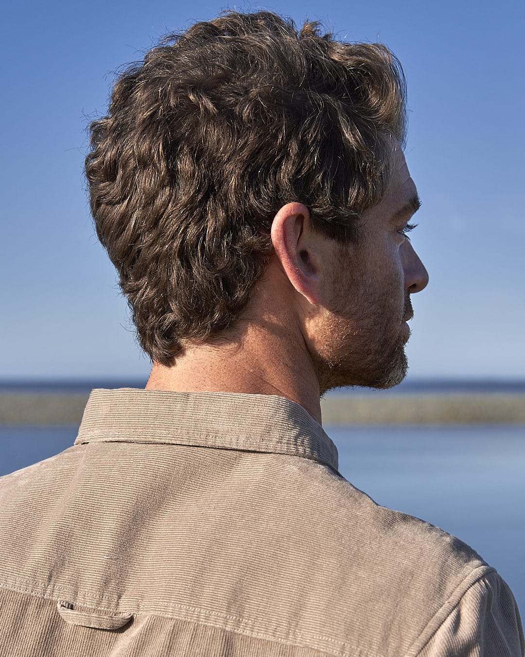 A man wearing a Saltrock Ace - Men Corduroy Shirt in Light Brown.