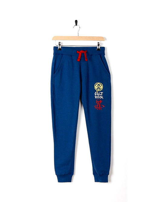 A Saltrock Activist A - Kids Jogger - Dark Blue with a red logo on it.