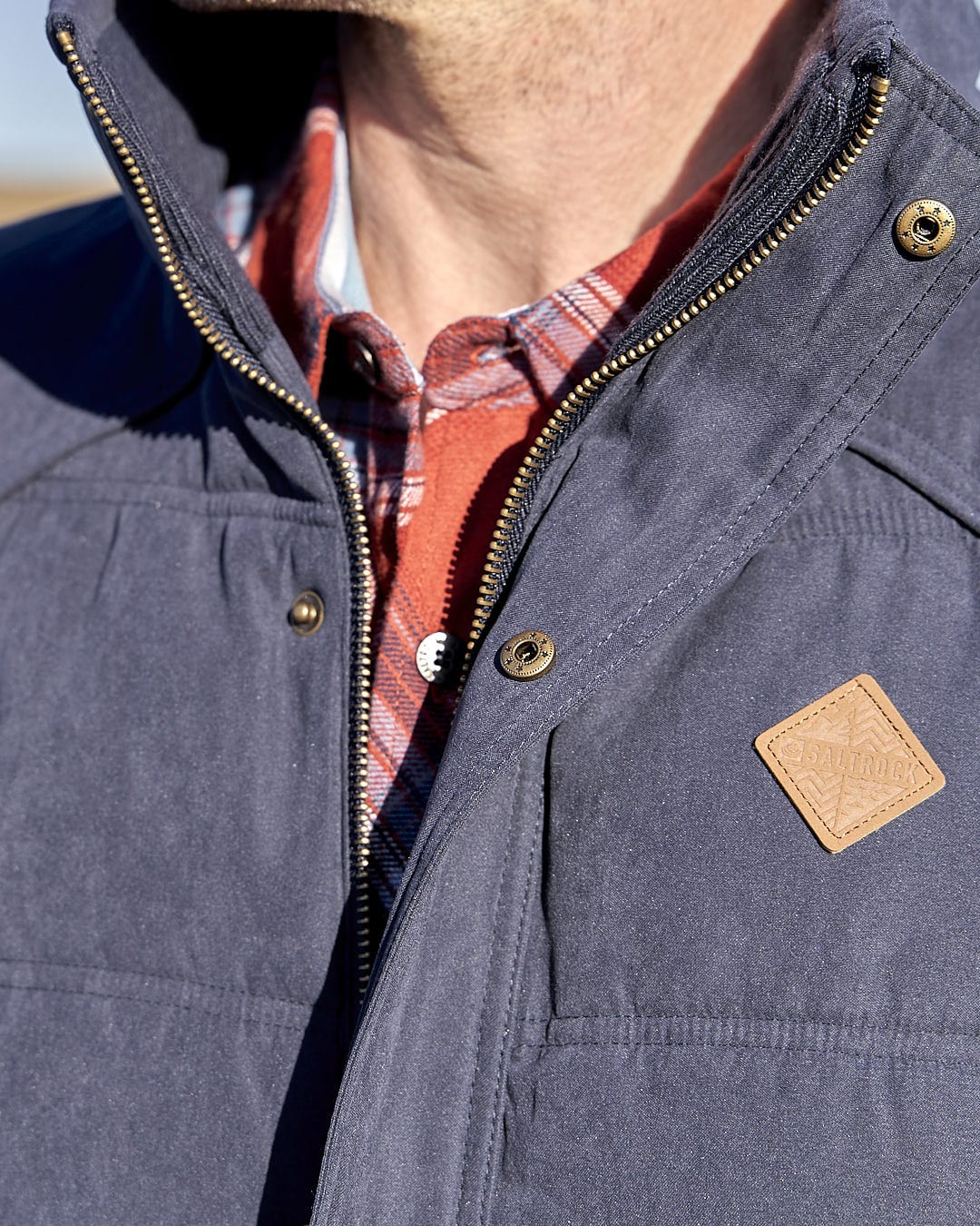 A man is wearing a Saltrock Bardsey - Mens Gilet - Blue with a hood.