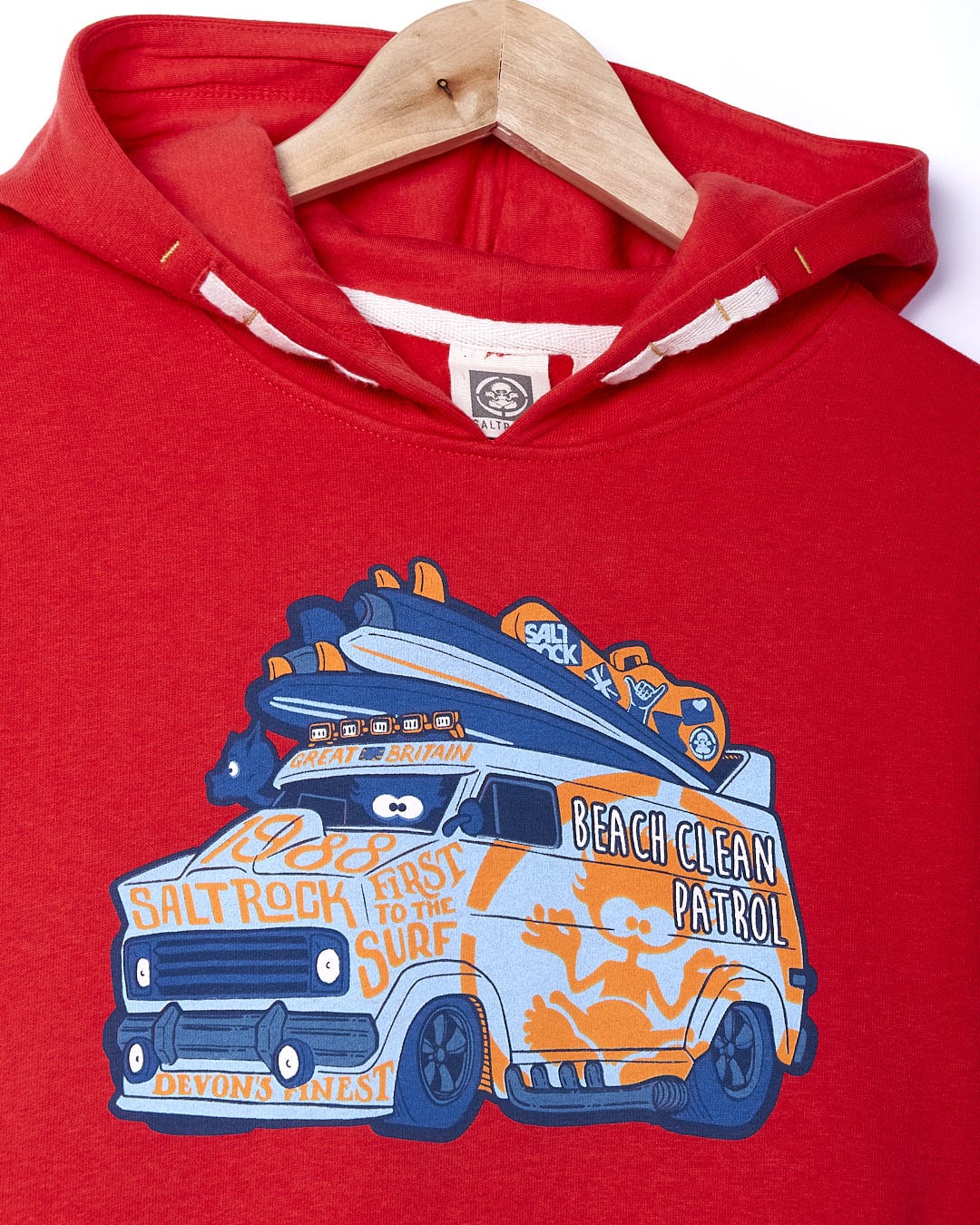 A Saltrock Beach Patrol - Kids Pop Hoodie - Red with an image of a van with surfboards on it.