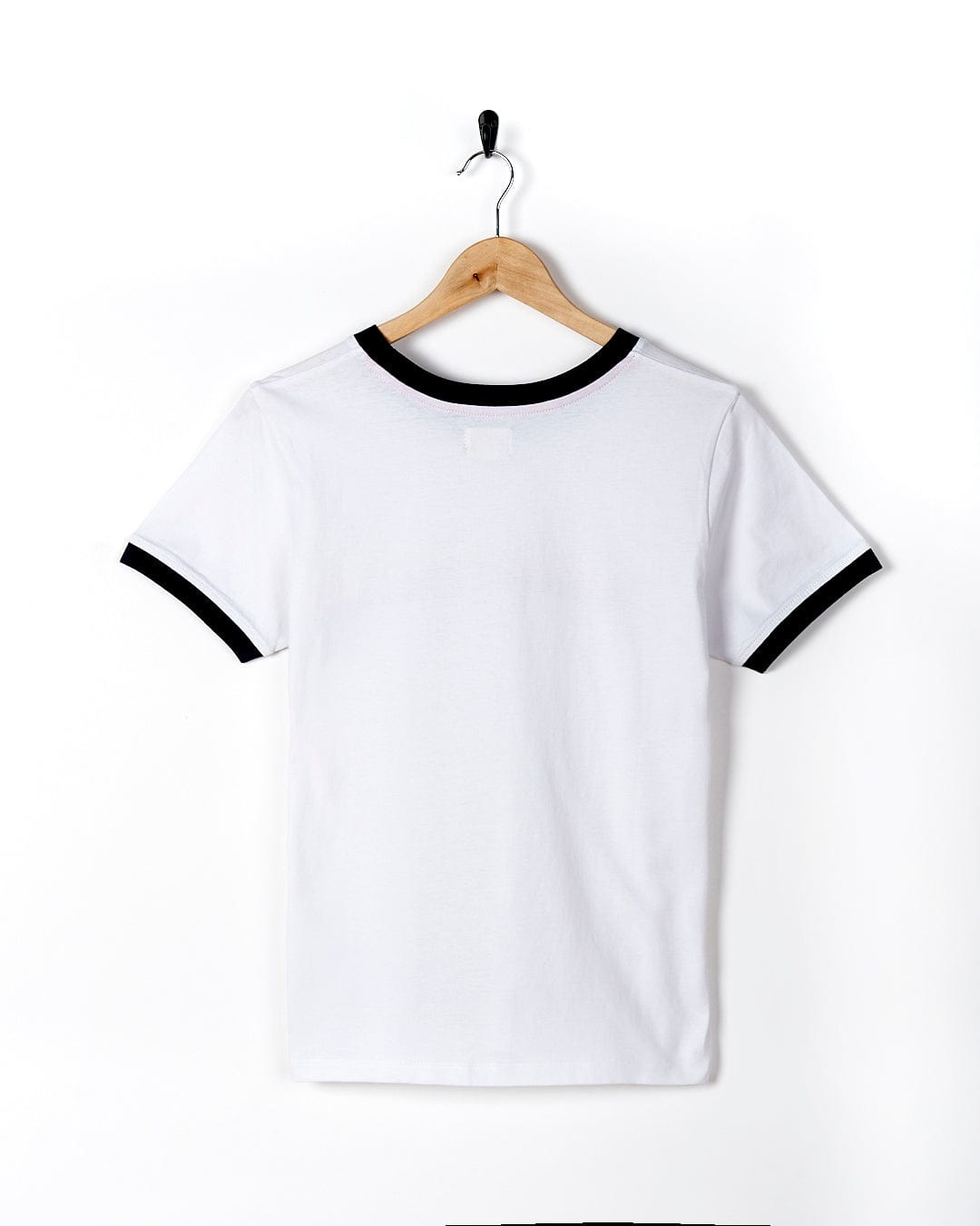 A Celeste Stripe - Womens Ringer Tee - White with black trim, perfect for showcasing your #SaltrockSoul, hanging neatly on a hanger.