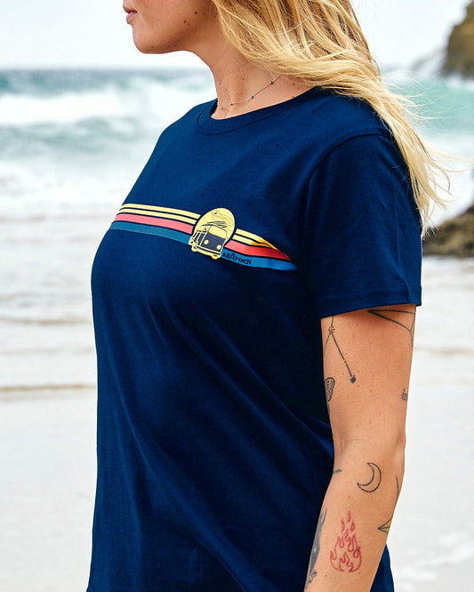 A woman wearing a Saltrock Celeste Stripe - Womens Short Sleeve T-Shirt - Blue on the beach.