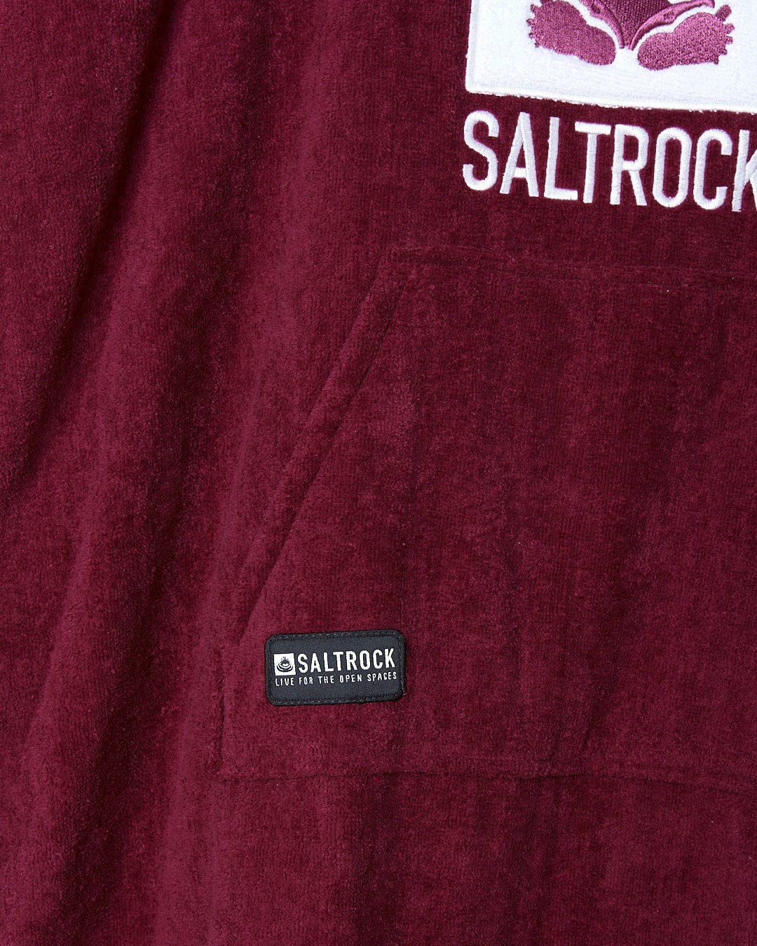 A maroon hoodie with the word Saltrock Classic Kids Changing Towel - Pink on it.