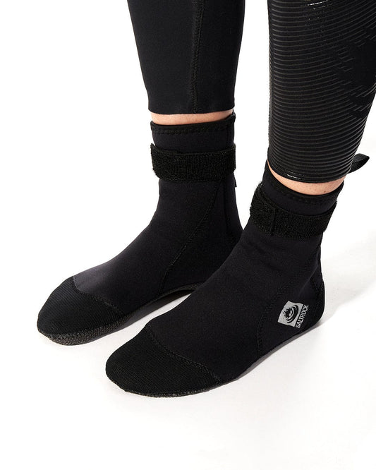 a woman wearing a pair of Saltrock Core - Wetsuit Boot - Black socks.