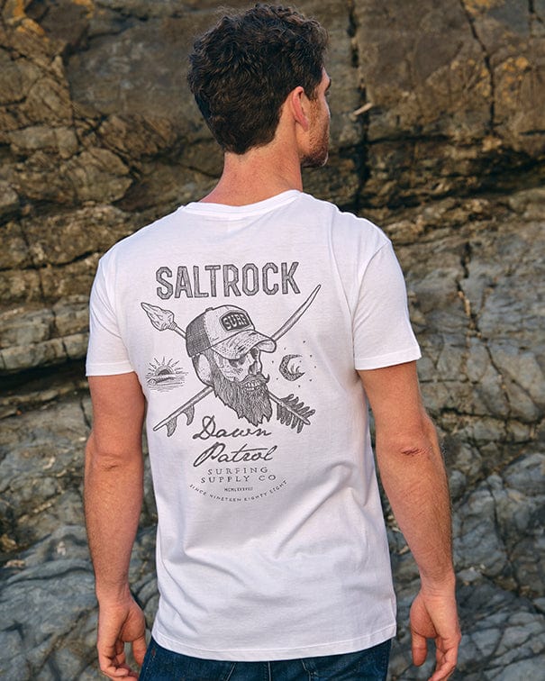 The back of a man wearing a Dawn Patrol - Mens Short Sleeve T-Shirt - White that says Saltrock.