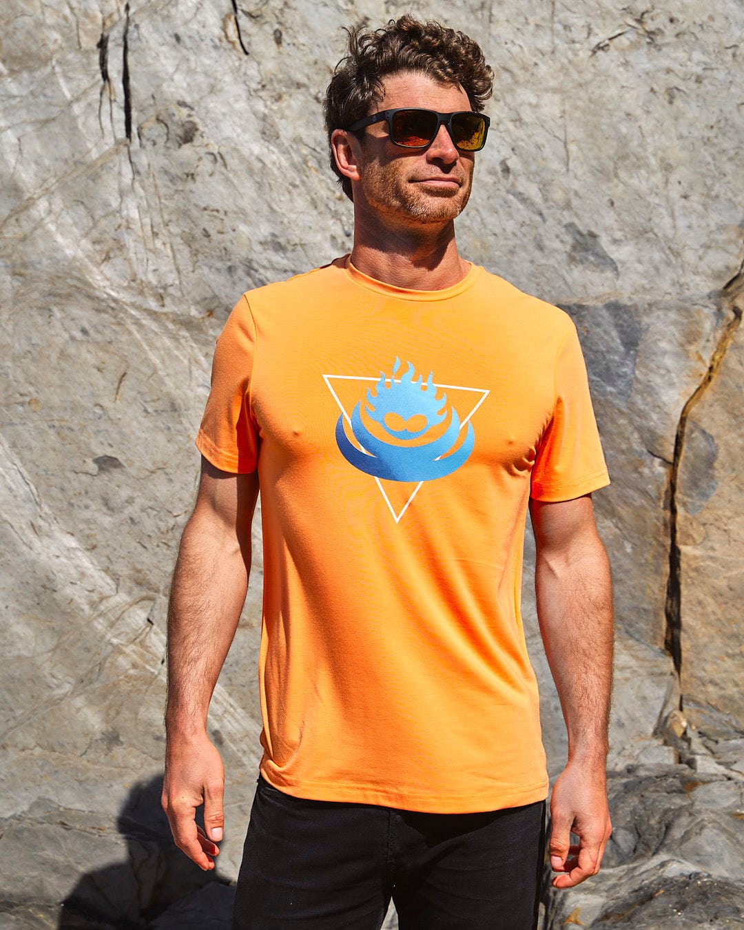 A man wearing sunglasses and a Saltrock Flame Tri - Mens Recycled Short Sleeve T-Shirt - Light Orange.