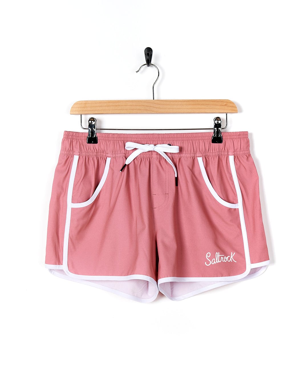 A Saltrock Fonte Volley - Womens Boardshort - Pink hanging on a hanger.