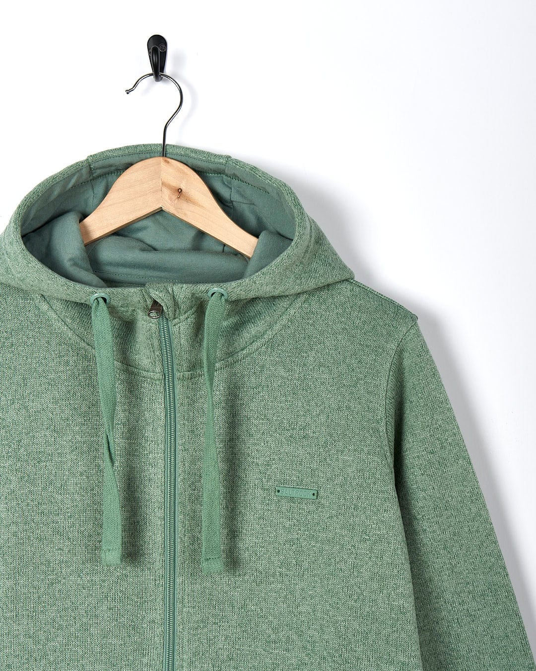 A Saltrock Galaksea - Womens 1/4 Zip Fleece - Light Green hoodie hanging on a hanger.