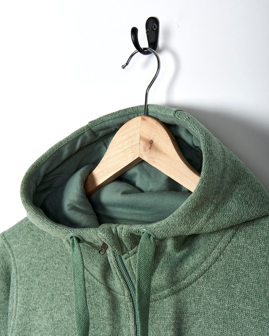 A Saltrock Galaksea - Womens 1/4 Zip Fleece - Light Green hoodie hanging on a hanger.