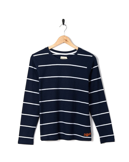 A Saltrock - Hartland Womens Striped Long Sleeve Tee - Blue hanging on a hanger.