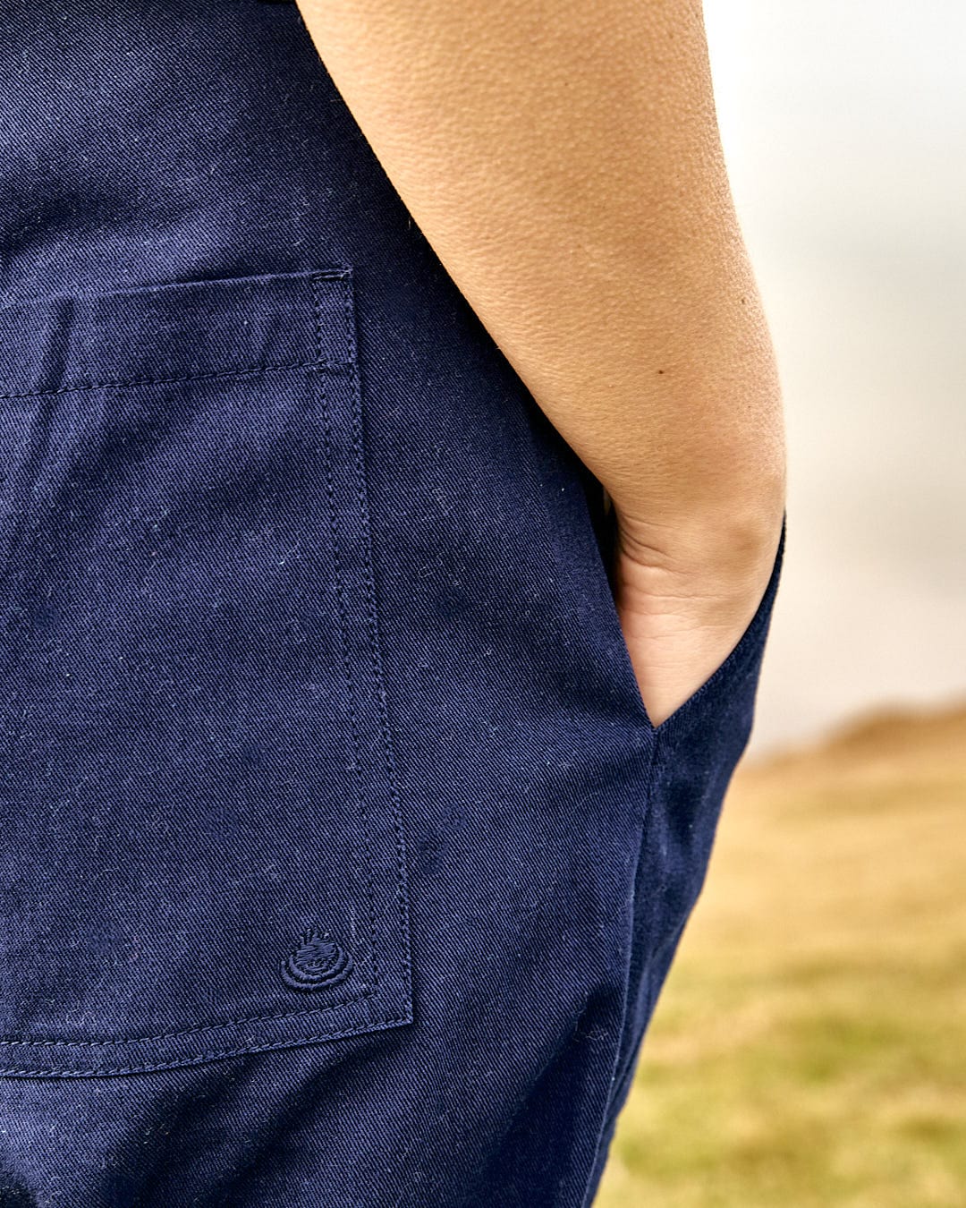 The back pocket of a person's Saltrock Hilda - Womens Canvas Trouser - Dark Blue pants.