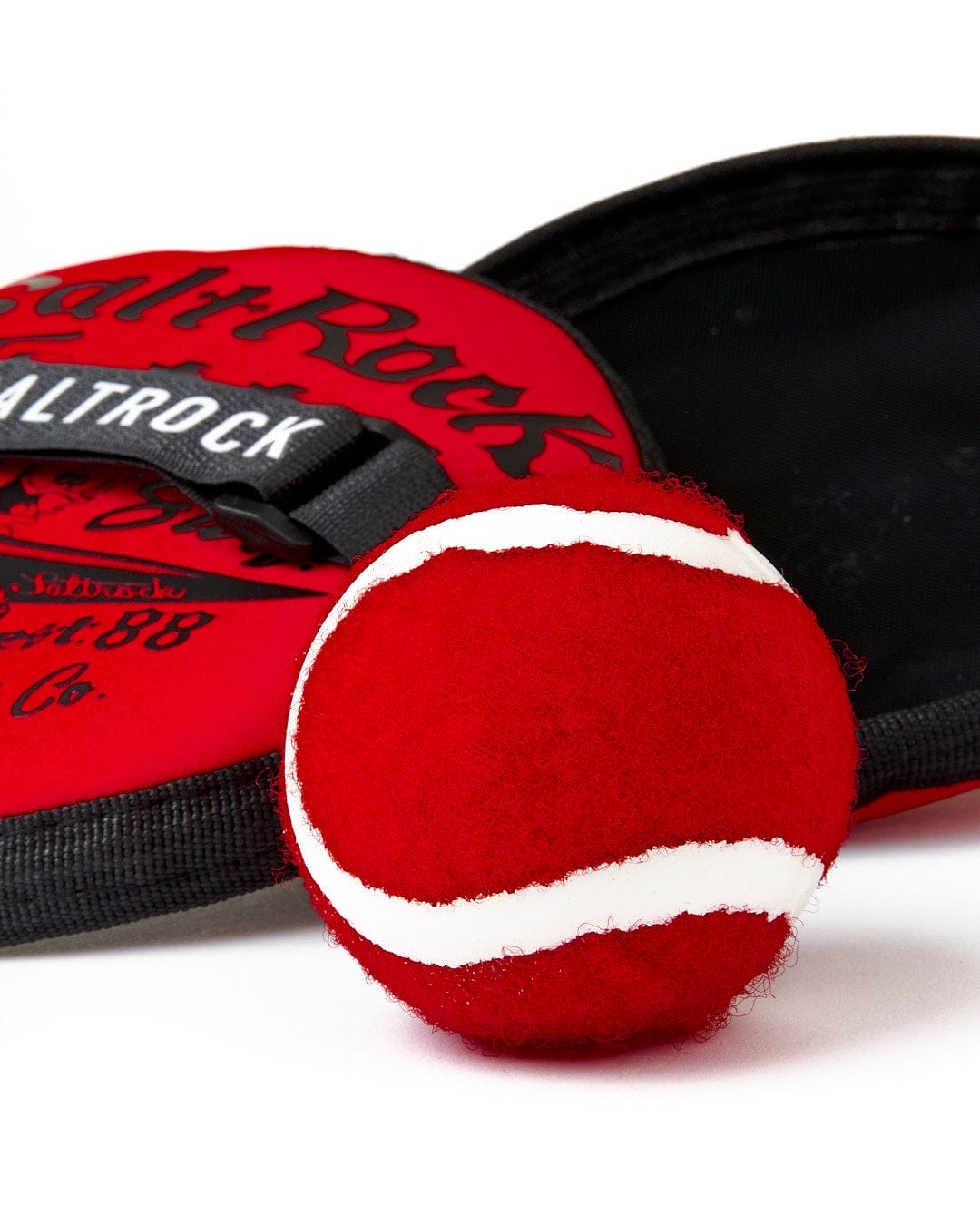 A Jonty - Catch Ball Set - Red and a black bag featuring Saltrock branding. Great for beach games like Catch Ball Set.