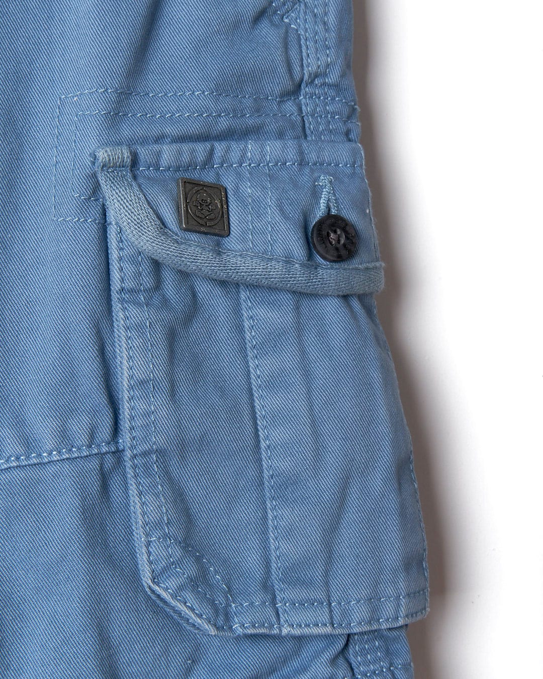 A pair of Saltrock Kaleb - Kids Cargo Shorts - Light Blue with buttons on the pockets.