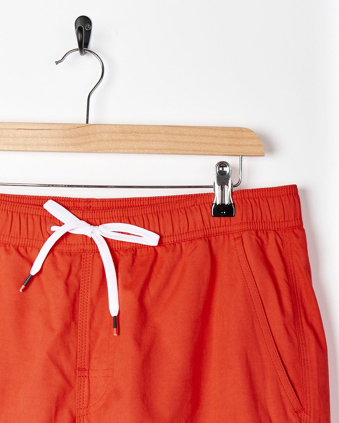 A pair of Red Lee - Mens Sueded Volley Swimshorts hanging on a hanger.