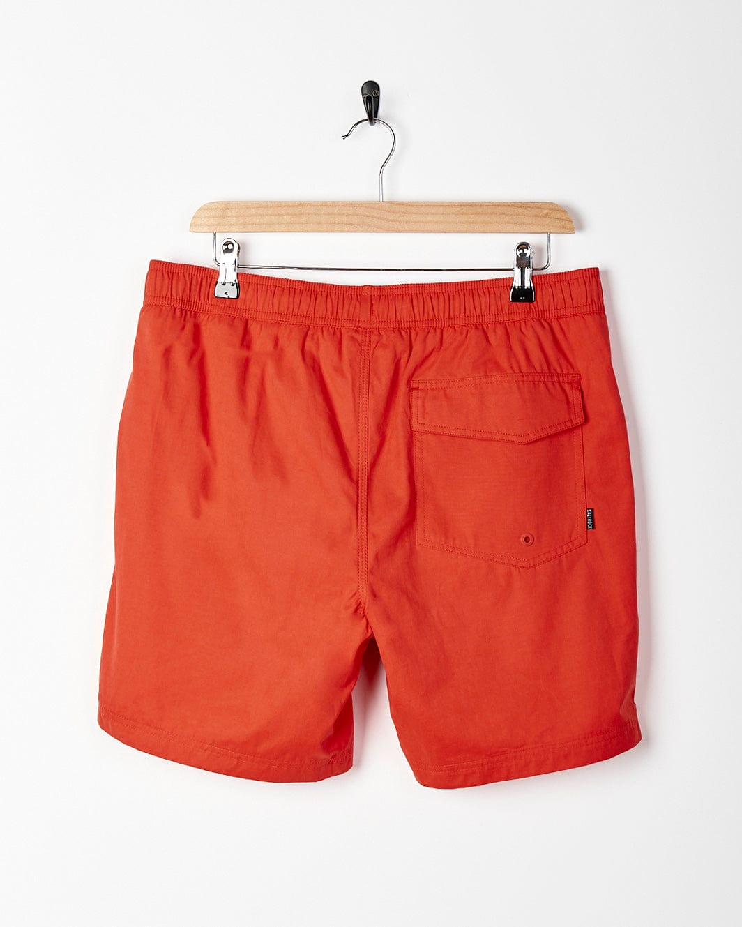 A Saltrock - Lee Mens Sueded Volley Swimshort - Red hanging on a hanger.