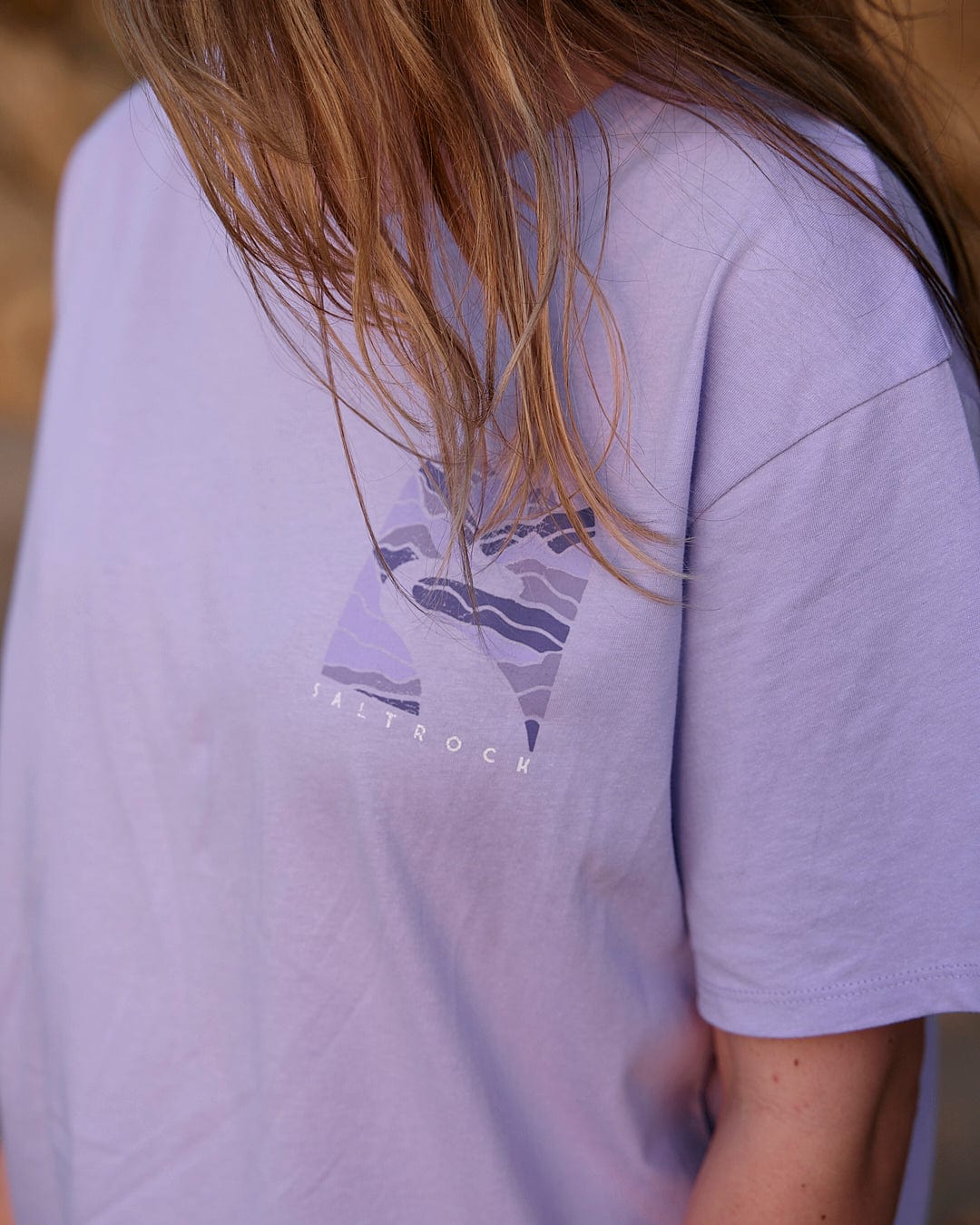 A woman wearing a Saltrock Live Wild - Womens Short Sleeve T-Shirt - Light Purple.