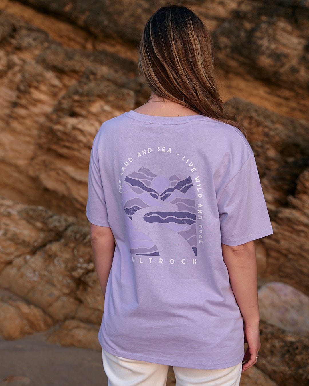 The back of a woman wearing a Saltrock Live Wild - Womens Short Sleeve T-Shirt - Light Purple.