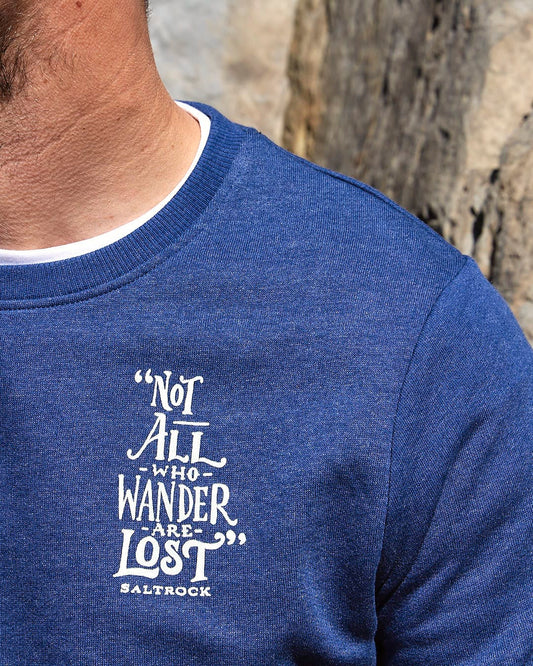 A man wearing a Saltrock Lost Ships - Mens Crew Sweat - Dark Blue sweatshirt with the words not all that wander lost.