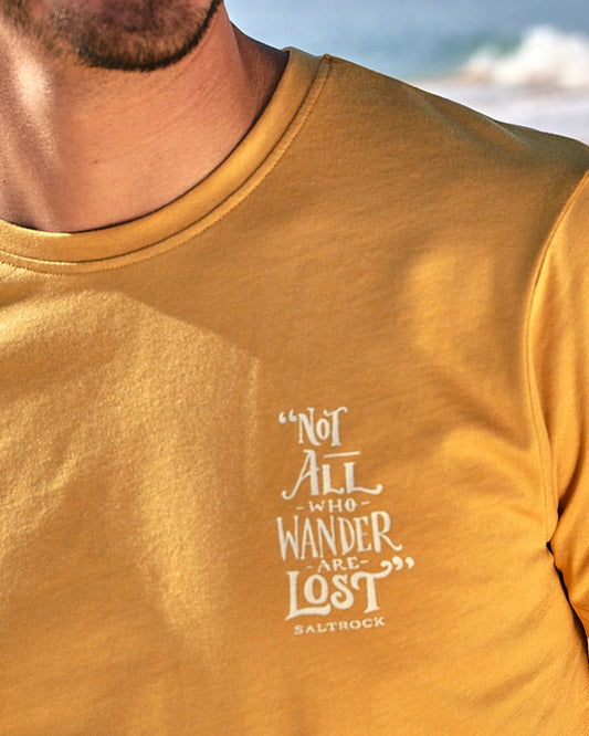 A man wearing a Saltrock Lost Ships - Mens Short Sleeve T-Shirt - Yellow that says not all wander lost.