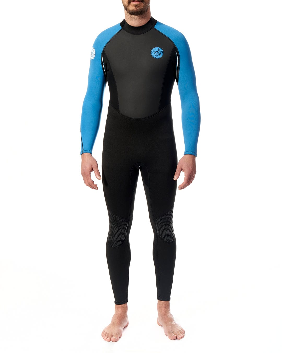 A man is standing in front of a white background in a Saltrock Core - Mens 3/2 Full Wetsuit - Blue/Black.
