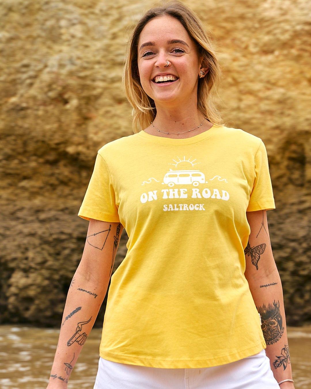 A woman wearing a Saltrock On The Road - Womens Short Sleeve T-Shirt - Yellow.