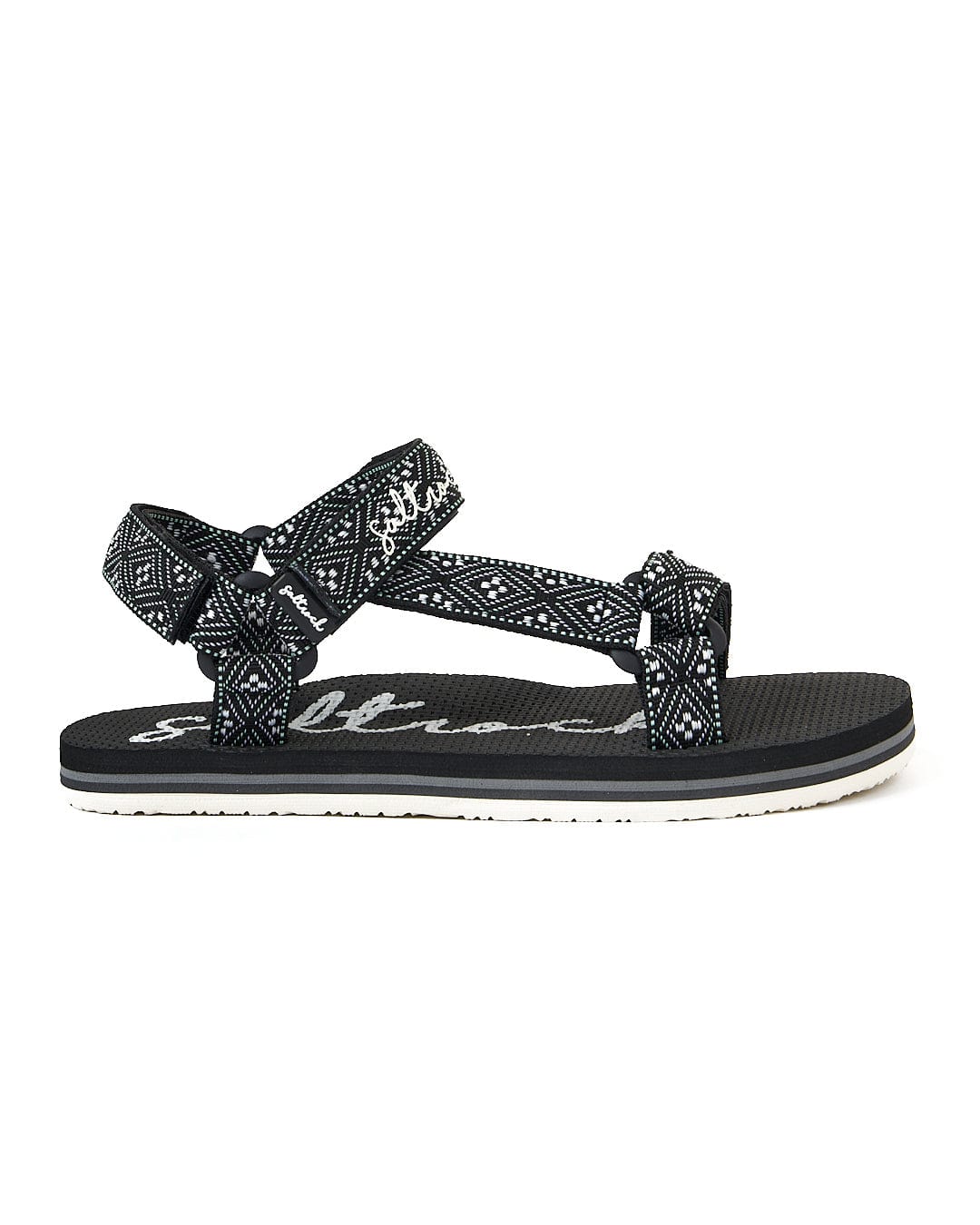 A pair of Saltrock Path Finder - Webbing Sandal - Black with a white polka dot pattern.