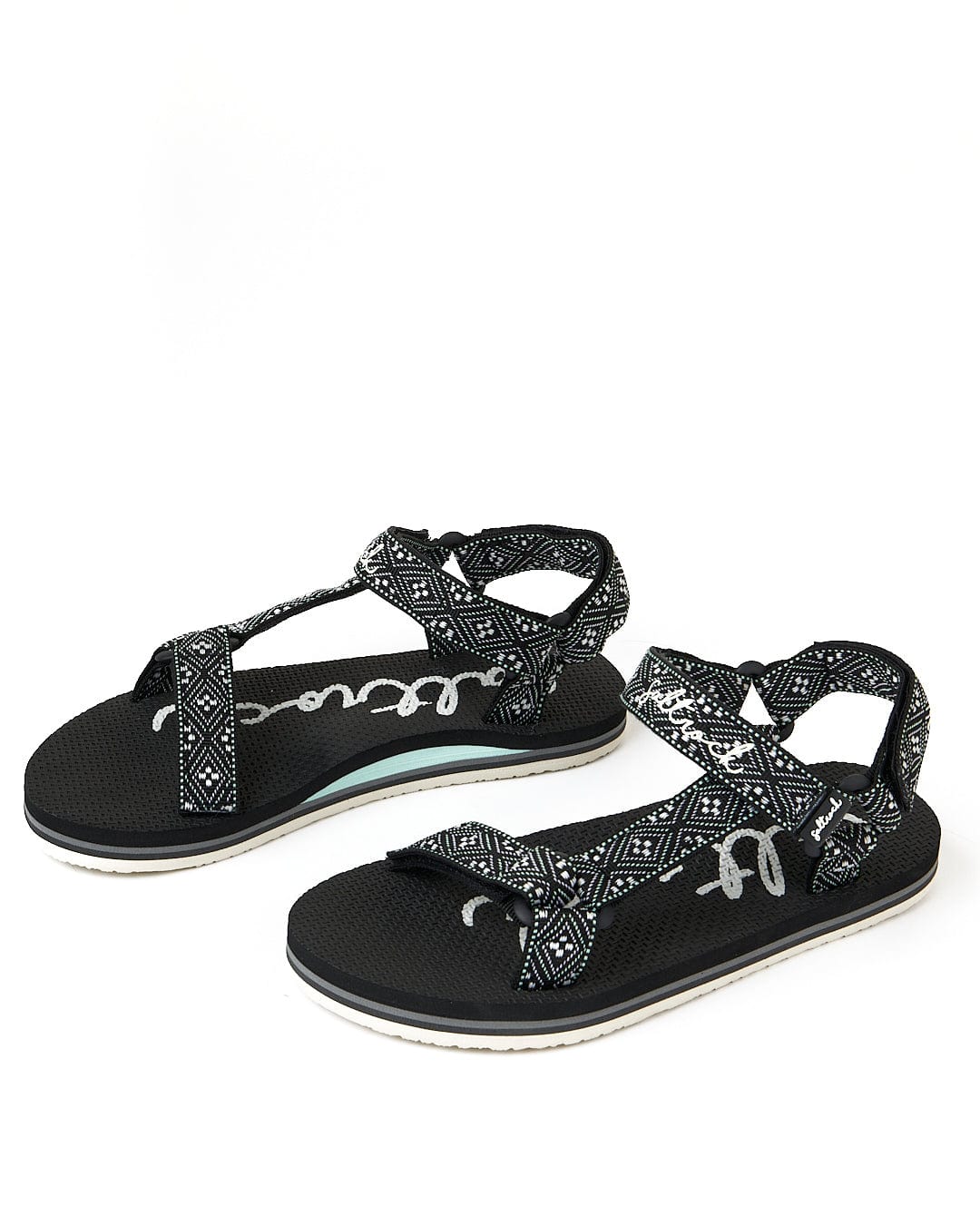 A pair of black and white Saltrock Path Finder - Webbing Sandals on a white background.