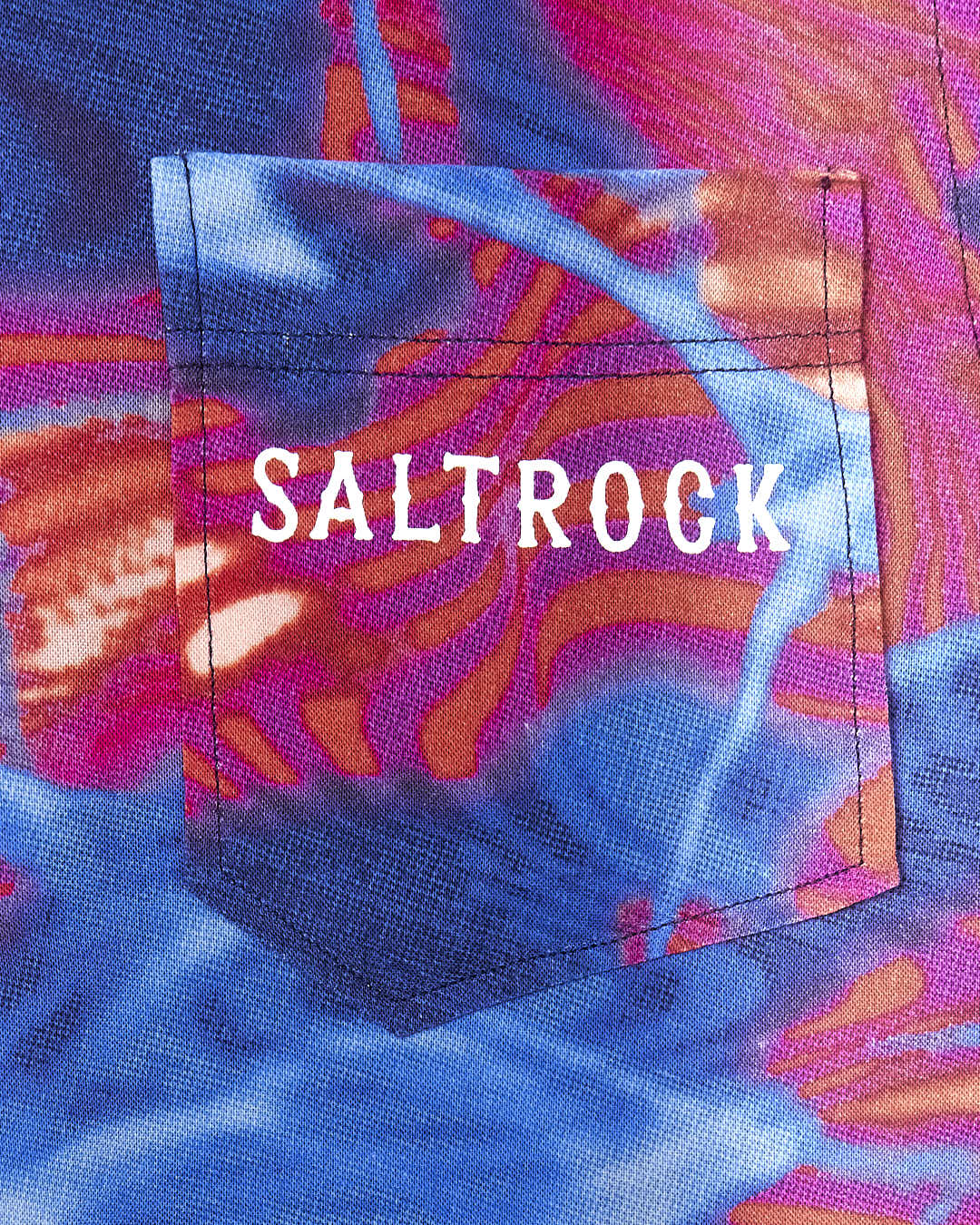A pocket with the brand name Saltrock and the product name Poolside - Kids All Over Print Short Sleeve Shirt - Multi on it.