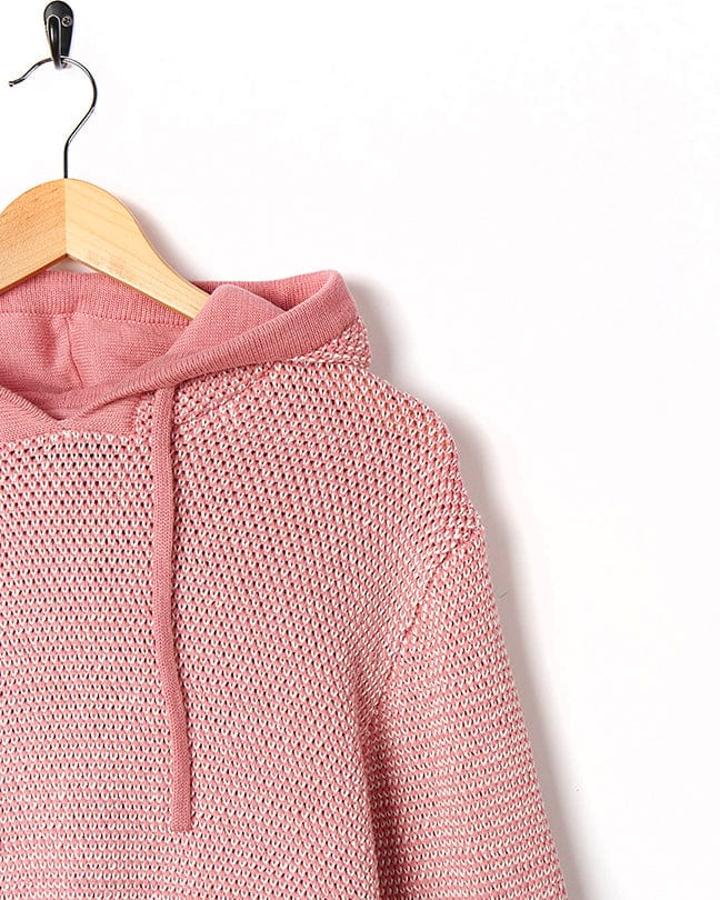A Poppy - Womens Knitted Pop Hoodie - Mid Pink by Saltrock hanging on a hanger.