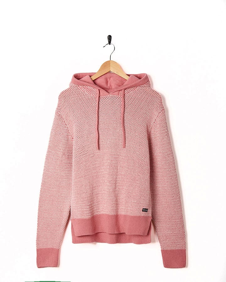A Poppy - Womens Knitted Pop Hoodie - Mid Pink by Saltrock hanging on a hanger.