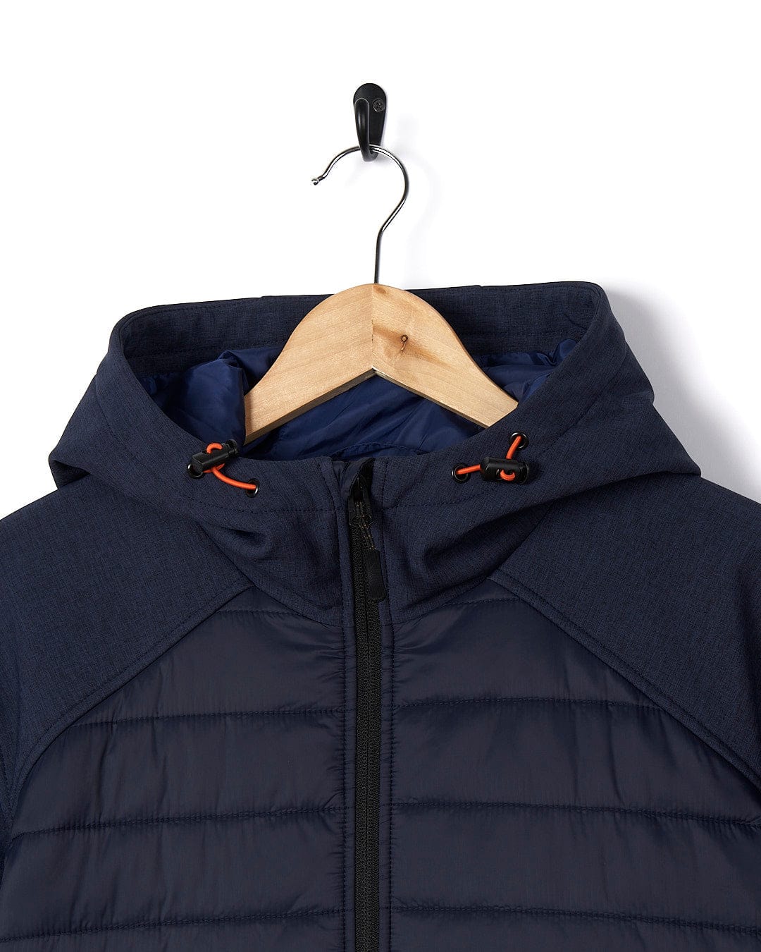 A Saltrock Purbeck Padded Jacket - Dark Blue hanging on a hanger, perfect for outdoor adventures.