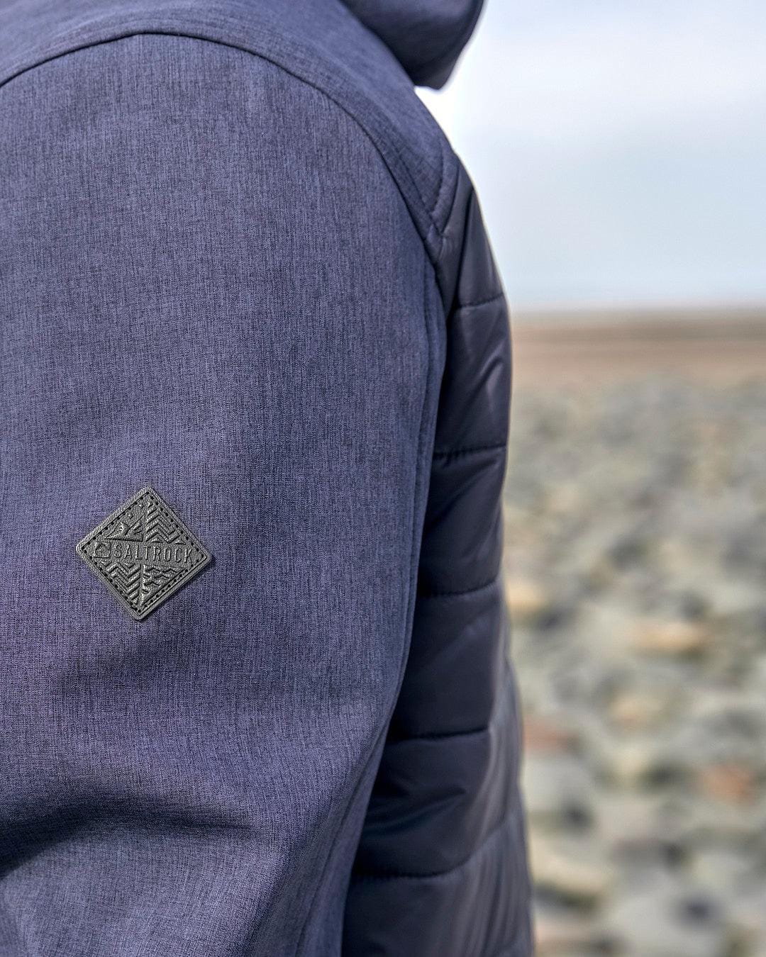 A Saltrock Purbeck Padded Jacket - Dark Blue for outdoor adventures.