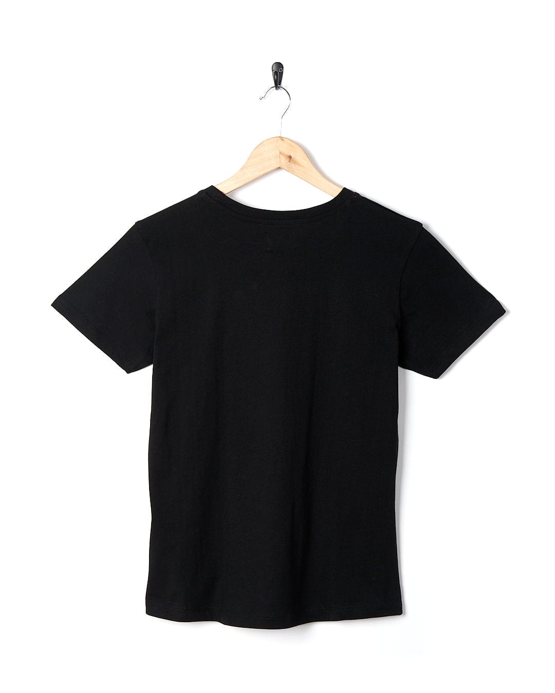 A Saltrock Purfect Wave Gradient - Womens Short Sleeve T-Shirt in black hanging on a wooden hanger.