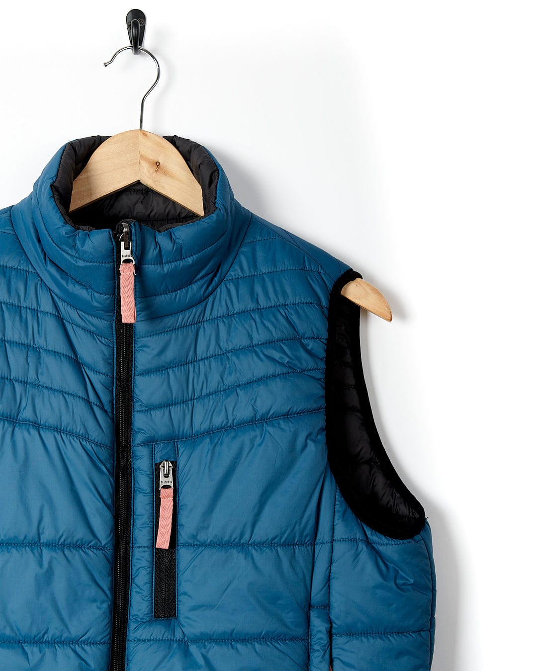 A Saltrock Ridleys - Womens Reversible Gilet - Blue hanging on a hanger.