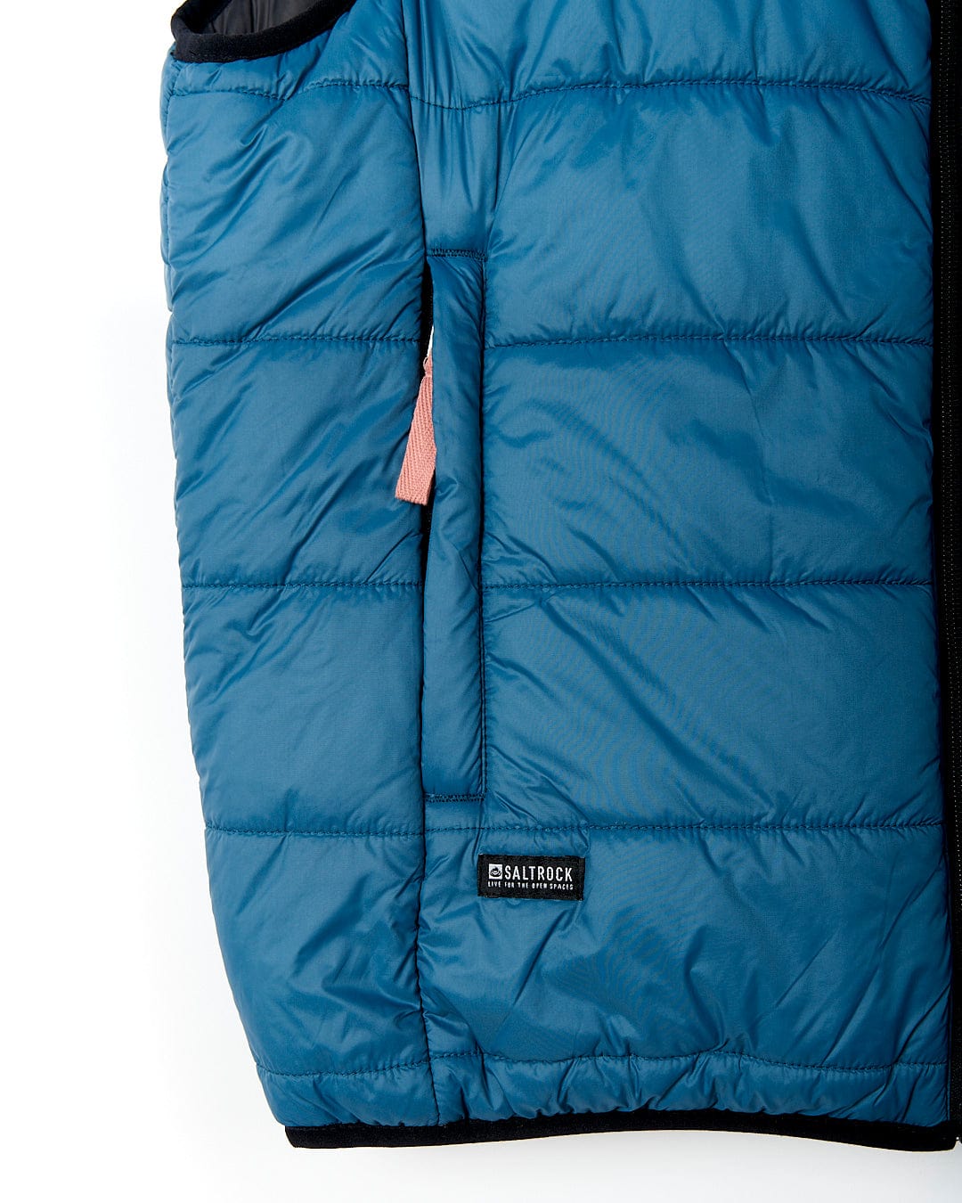 A Saltrock Ridleys - Womens Reversible Gilet - Blue, a water resistant blue puffy vest with a zippered pocket, perfect as a travel buddy.