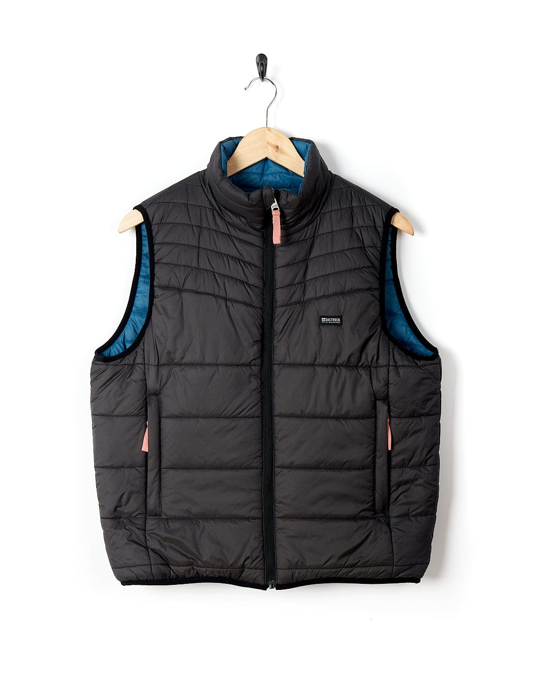 A water-resistant Saltrock blue puffy vest hanging on a hanger.