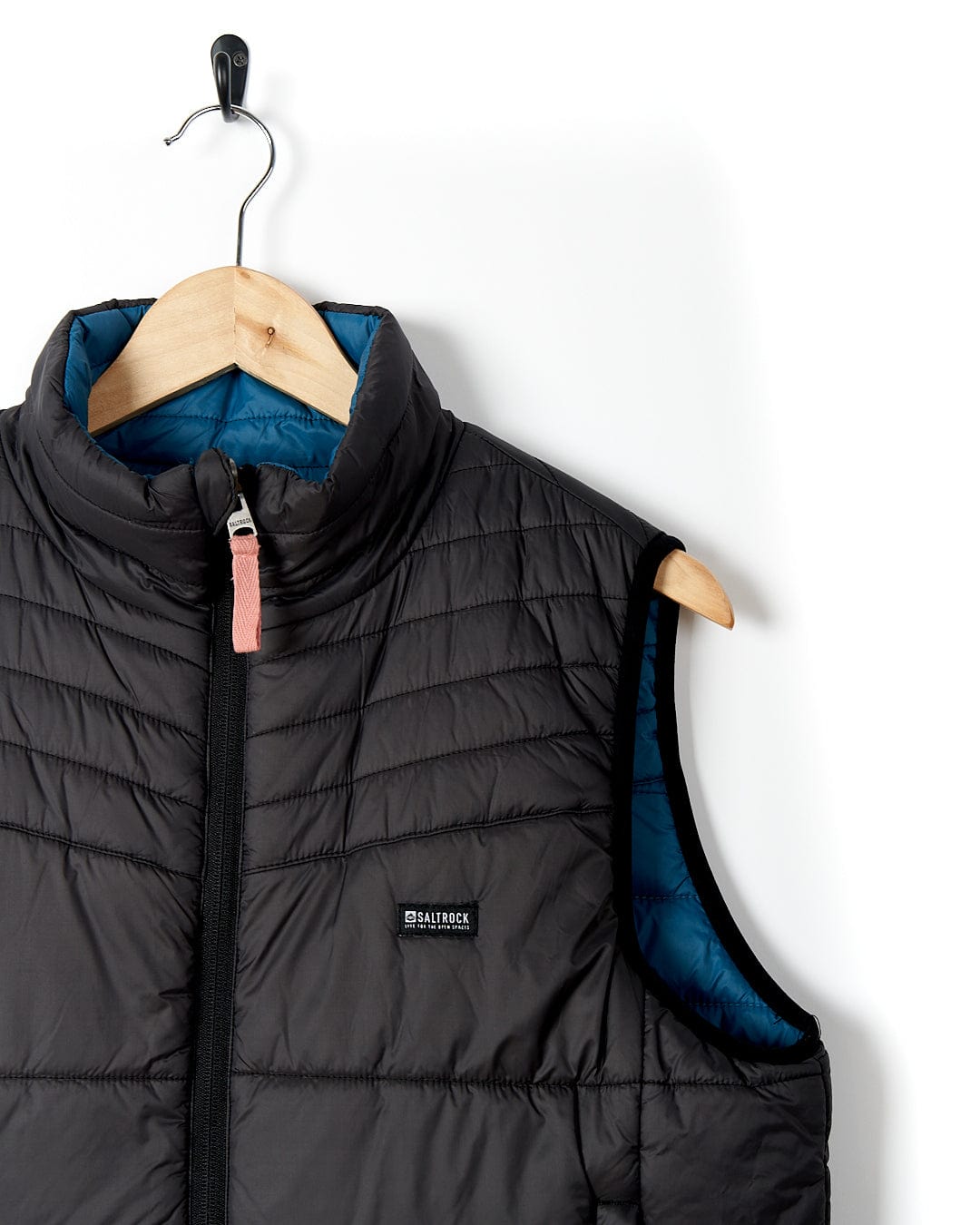 A water resistant Ridleys - Womens Reversible Gilet - Blue, the perfect travel buddy, hanging on a hanger. Brand Name: Saltrock