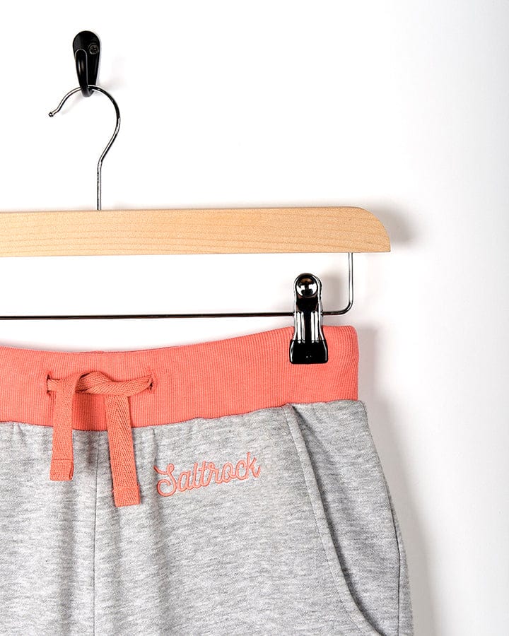 A pair of Road Panel - Kids Jogger - Grey sweatpants by Saltrock hanging on a hanger.