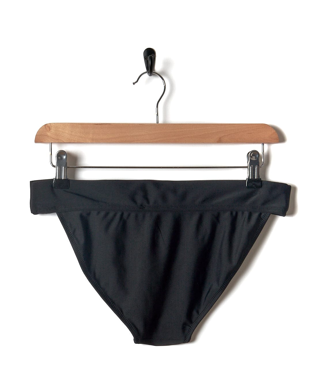 A Rosie - Women's Bikini Bottom - Black hanging on a Saltrock pool hanger.