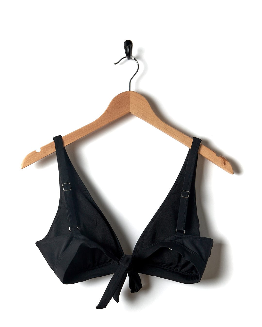 A Rosie - Womens Bikini Top - Black with adjustable straps hanging on a hanger.
