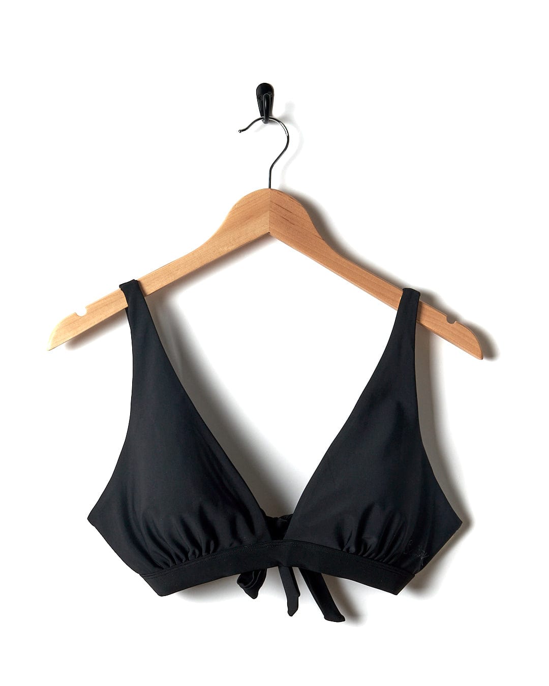 A durable Rosie Women's Bikini Top in black with adjustable straps, hanging on a hanger. Brand: Saltrock.