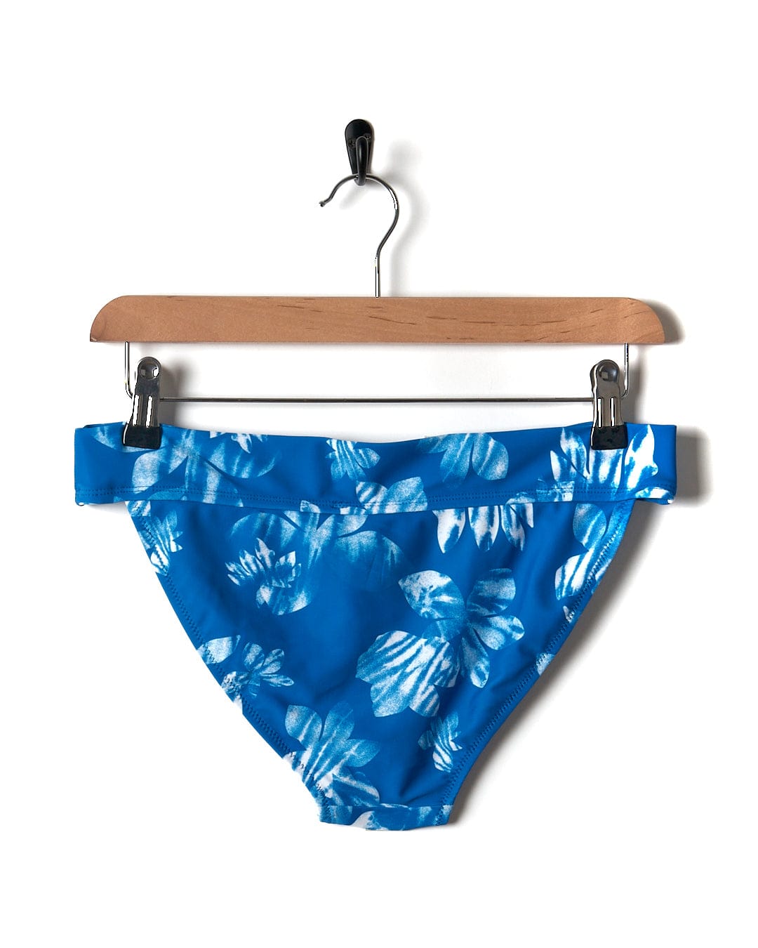 Saltrock's Rosie Floral Women's Bikini Bottom in Blue, hanging on a hanger, perfect for the pool or beach.