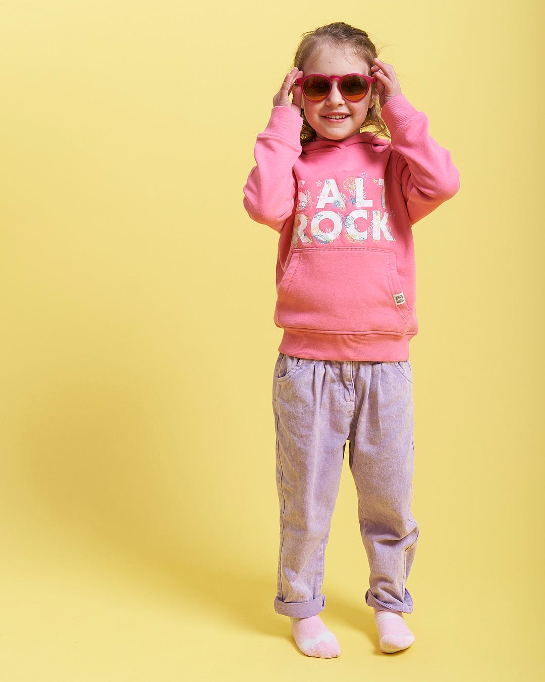 A little girl wearing Seabed - Kids Pop Hoodie - Pink by Saltrock.