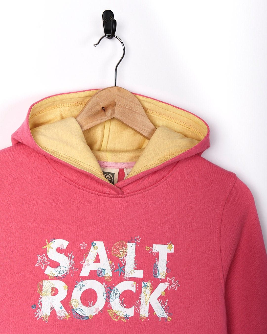 A Seabed - Kids Pop Hoodie - Pink with the brand name Saltrock on it.