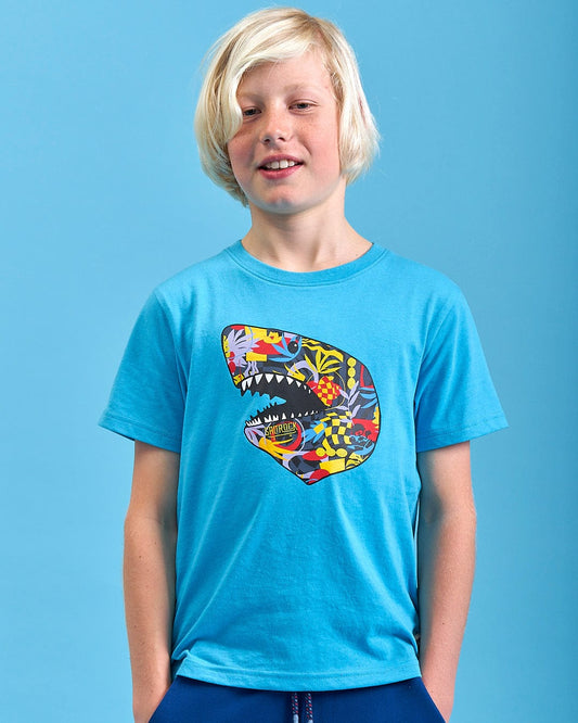 A young boy wearing a Saltrock Shark Mash Up Kids Short Sleeve T-Shirt in Teal.