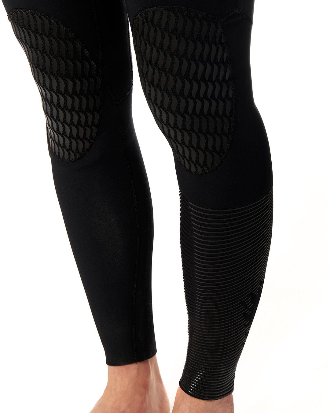 The legs of a man wearing a Saltrock Shockwave - Womens 3/2 Front Zip Full Wetsuit - Black.