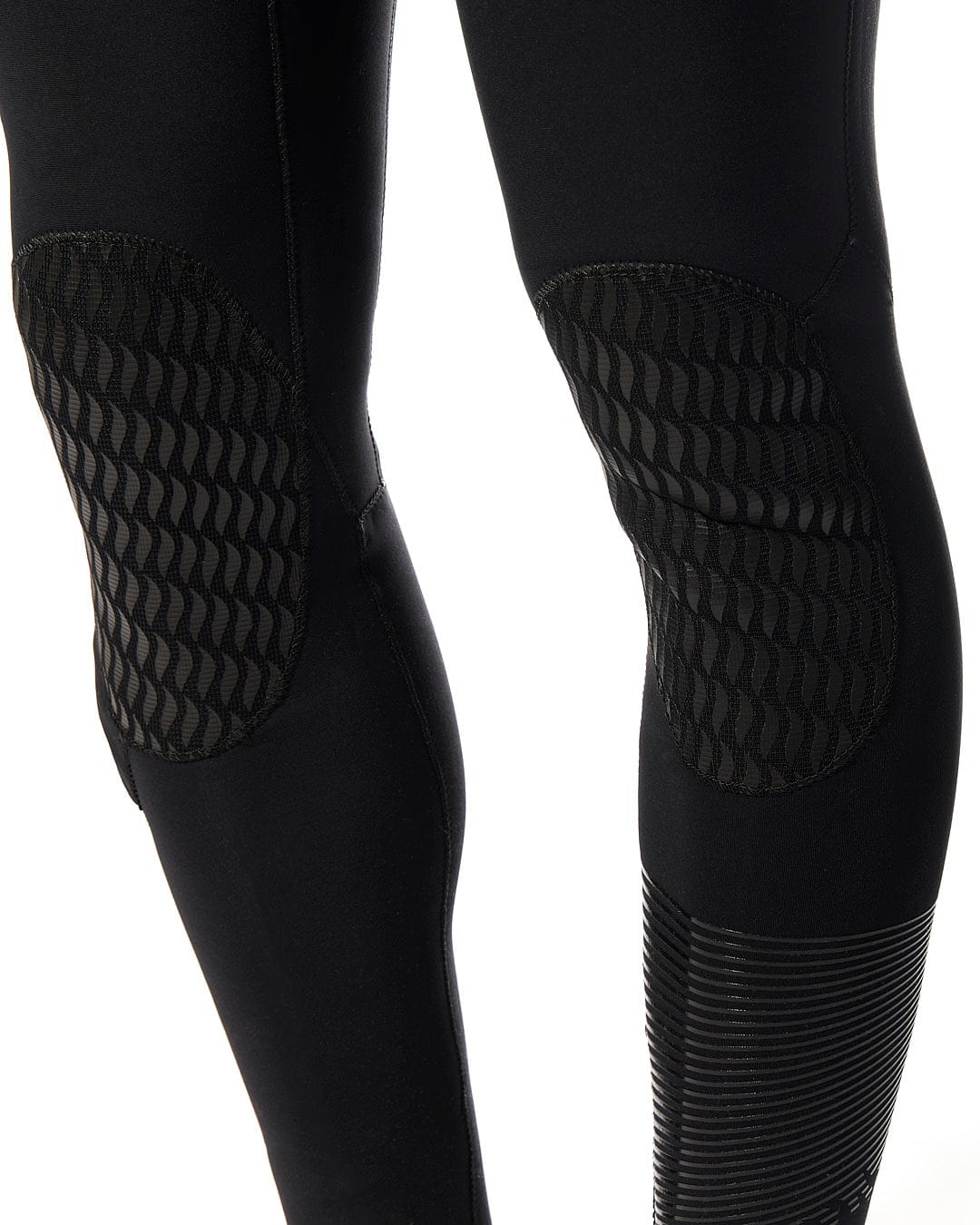 The legs of a man wearing a Saltrock Shockwave - Mens 3/2 Chest Zip Full Wetsuit - Black.