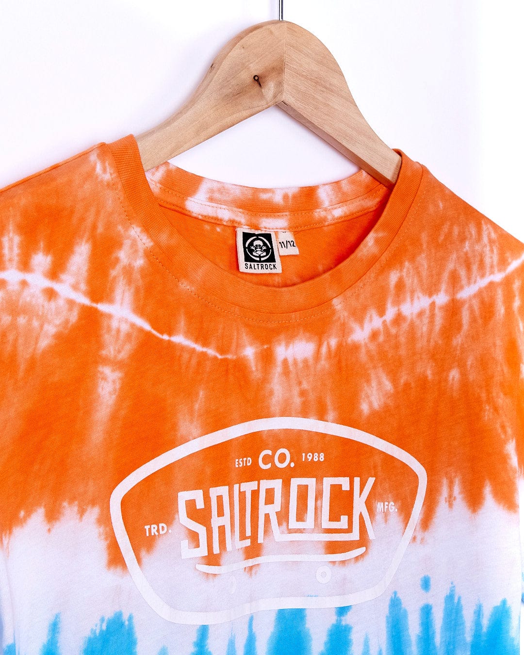 A Saltrock Sunray Skate - Boys Tie Dye Short Sleeve T-Shirt - Orange with the word saurrock on it.