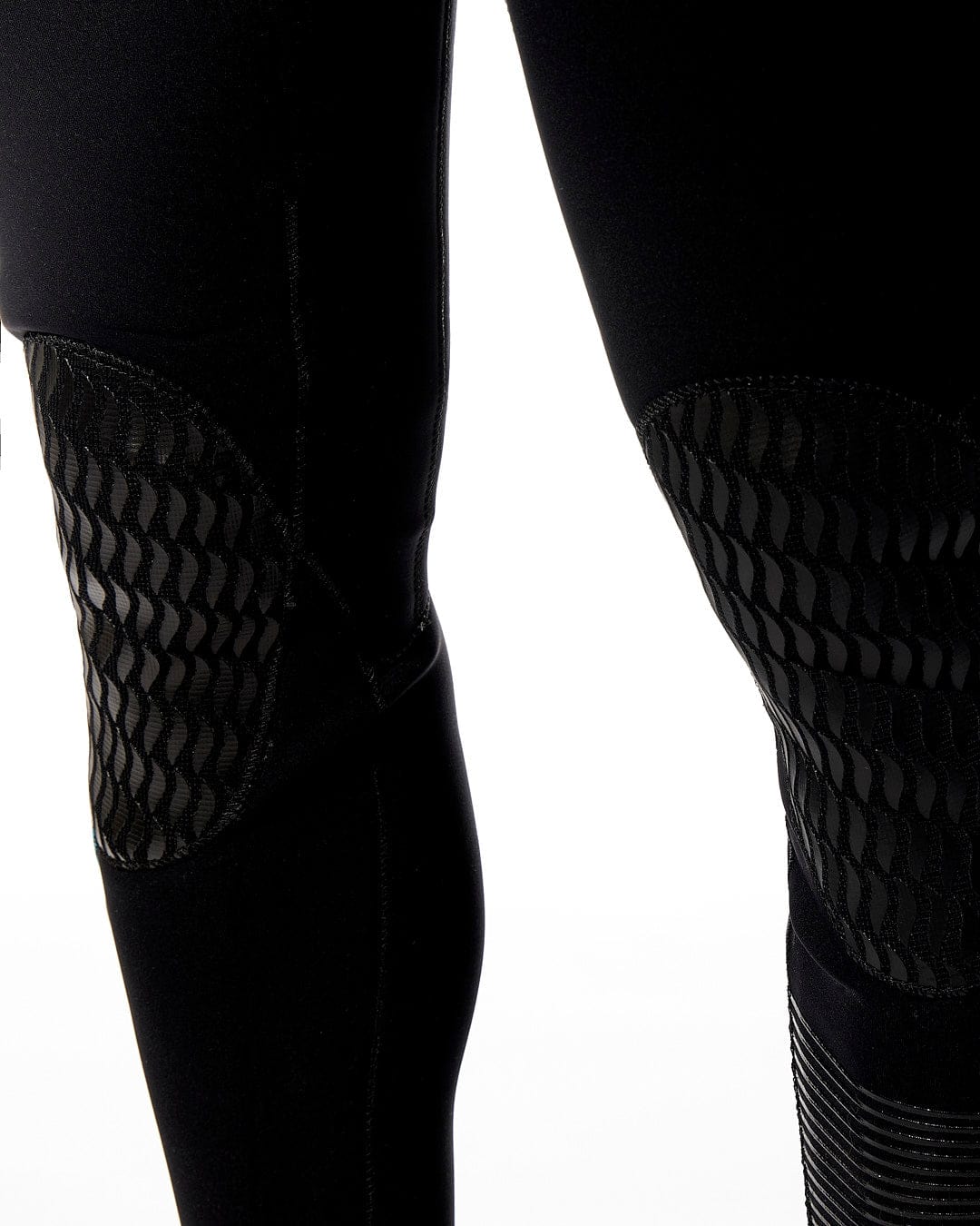 The legs of a man wearing a pair of Saltrock Synthesis Mens 4/3 Back Zip Full Wetsuit - Black.